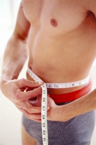 man measuring waist