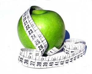 green apple with measuring tape